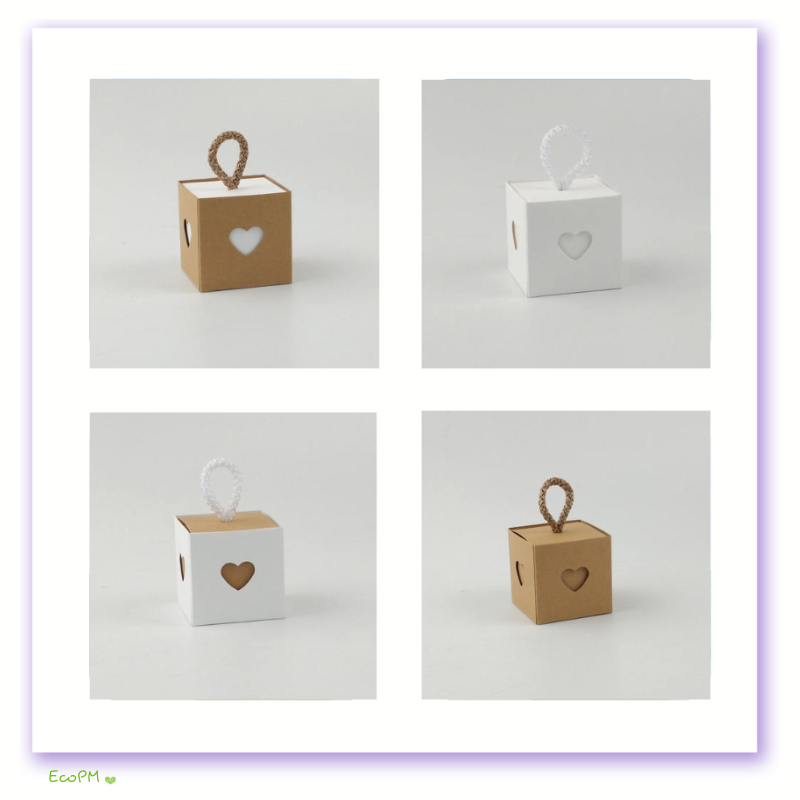 heartfelt-kraft-favor-box-set-50pcs.png Four small cubic favor boxes, two kraft and two white, each with a heart-shaped cutout and a twine handle, part of a 50-piece set.