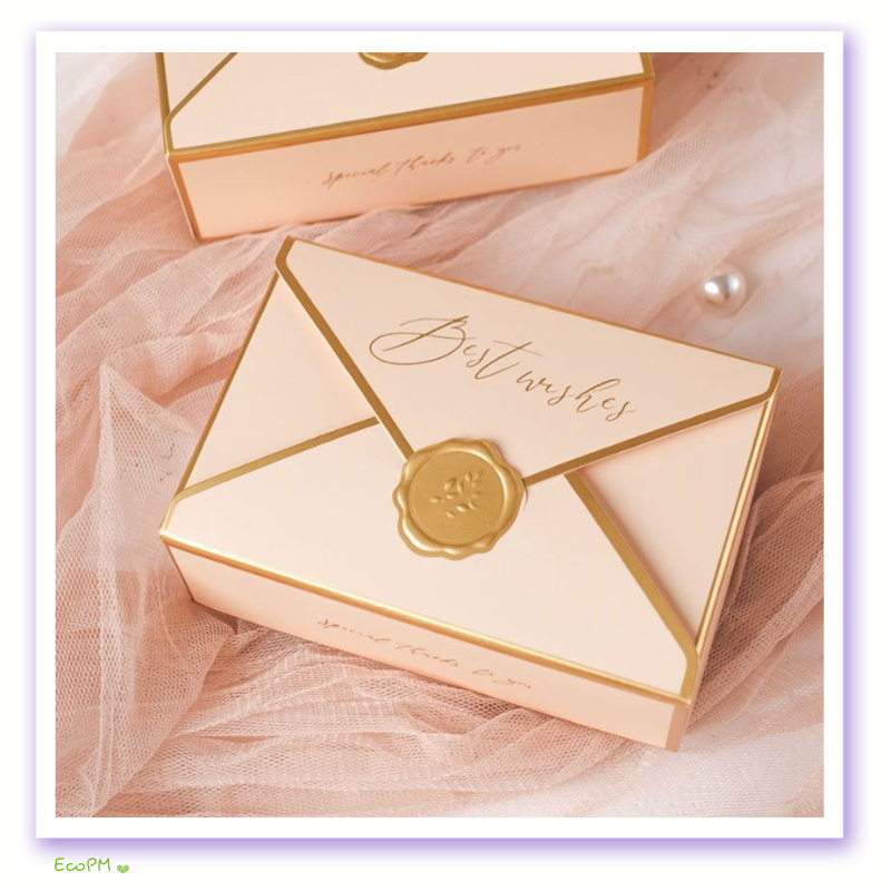 blush-elegance-wax-seal-favor-box-set.png A blush pink favor box with golden trim and a wax seal, inscribed with 'Best wishes', conveying luxurious sentiments.