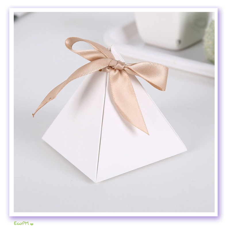pyramid-elegance-favor-box-satin-ribbon.jpg Elegant white pyramid favor box tied with a champagne satin ribbon on a neutral background.