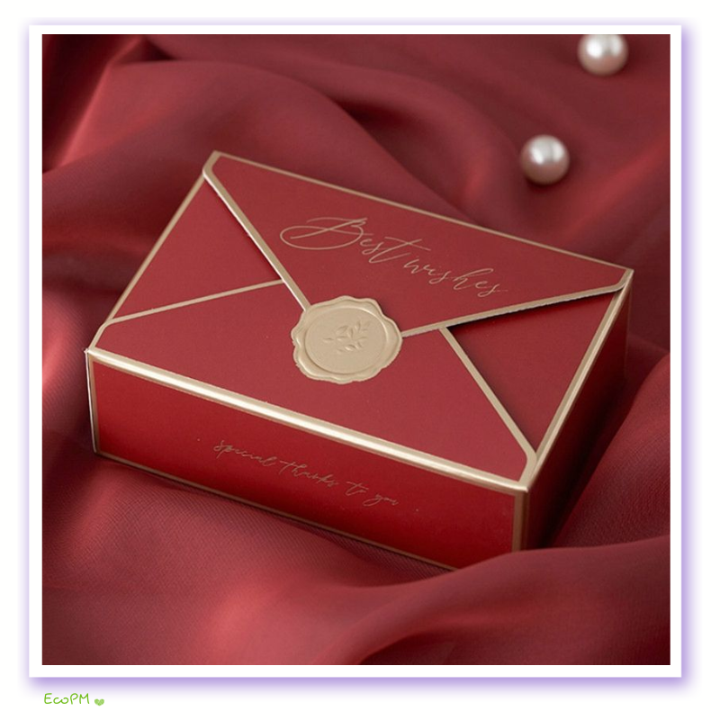 red-elegance-best-wishes-favor-box.png A luxurious red favor box with a white wax seal and 'Best Wishes' inscription, perfect for exclusive event gifting.