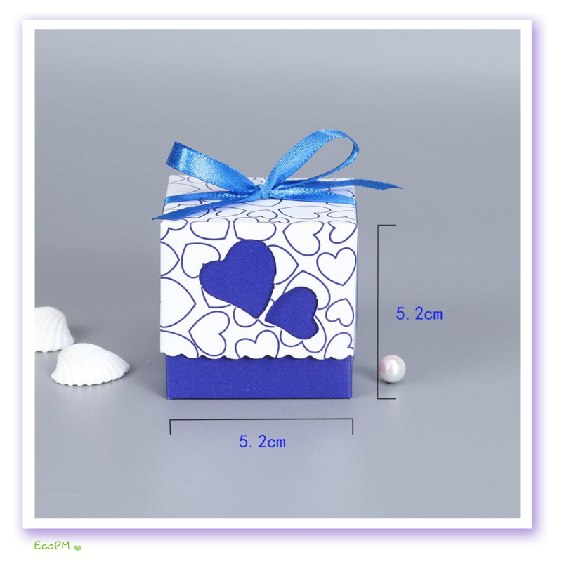 blue-heart-elegance-favor-box.png A charming blue and white heart-patterned favor box tied with a bright blue ribbon, sized at 5.2 cm, perfect for wedding or party gifts.