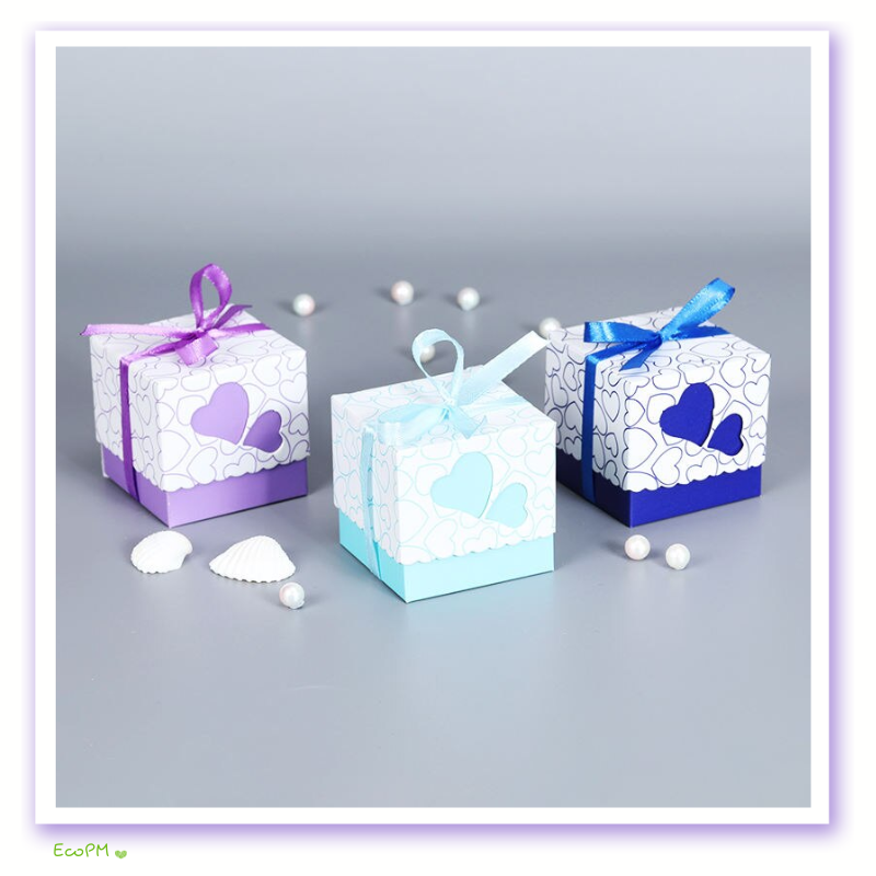 charming-collection-heart-favor-boxes-set.png Assorted heart-print favor boxes in purple, blue, and white, adorned with matching ribbons and pearls.