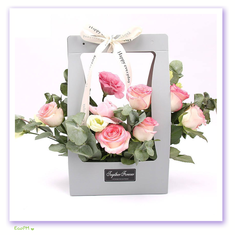 grey-eco-friendly-flower-bag.png Elegant grey paper flower bag with cream ribbon and assorted pink roses.