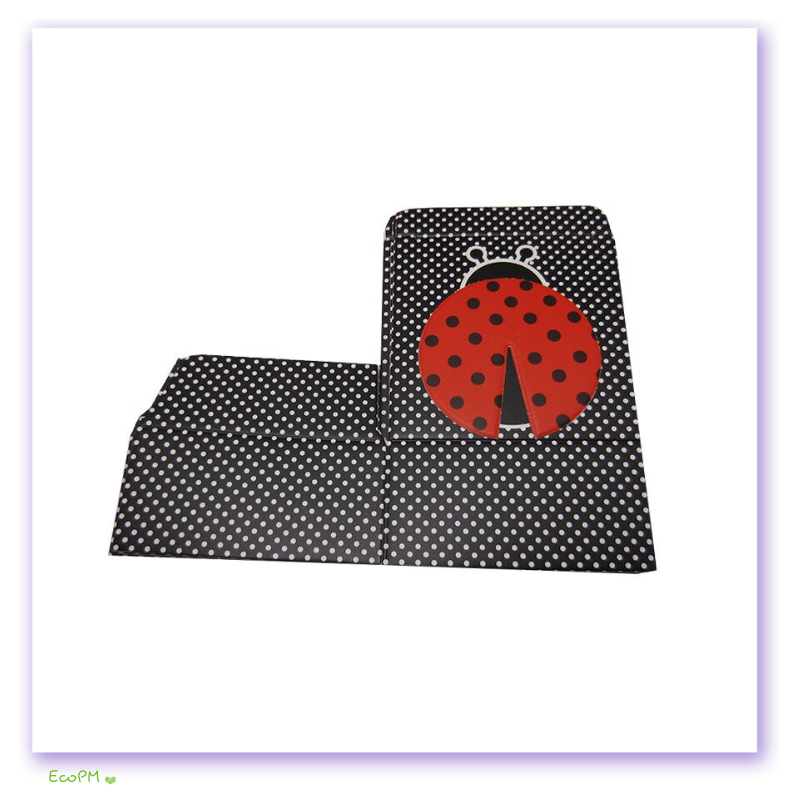 ladybug-charm-favor-box-unassembled.png Unassembled favor box with black and white polka dot pattern and a red ladybug-themed lid.