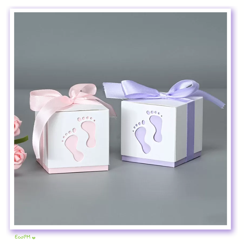 pastel-baby-shower-favor-box-footprint-design.png Delicate baby shower favor boxes in pastel pink and lilac, adorned with matching satin ribbons and footprint cutouts, perfect for baby shower gifts and decorations.
