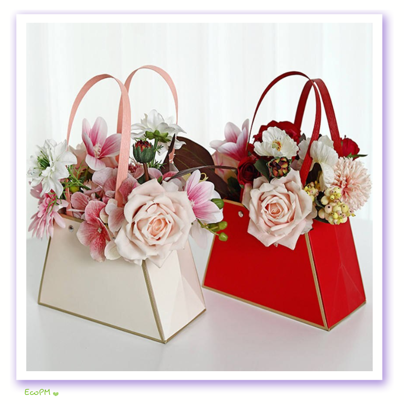 two-tone-flower-bags.png Two elegant paper flower bags in beige and red, filled with a vibrant mix of roses, lilies, and other seasonal blooms.