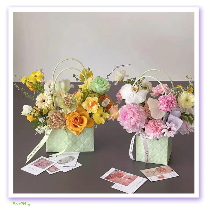 pastel-paradise-paper-flower-bag.png Two pastel paper flower bags with a variety of fresh spring flowers on a grey background.