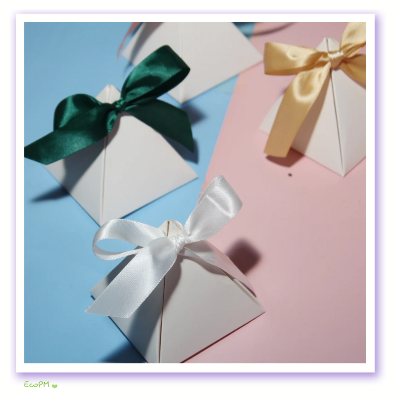 assorted-satin-ribbon-pyramid-gift-boxes.png Assorted pyramid gift boxes with satin ribbons in various colors on a dual-tone background.