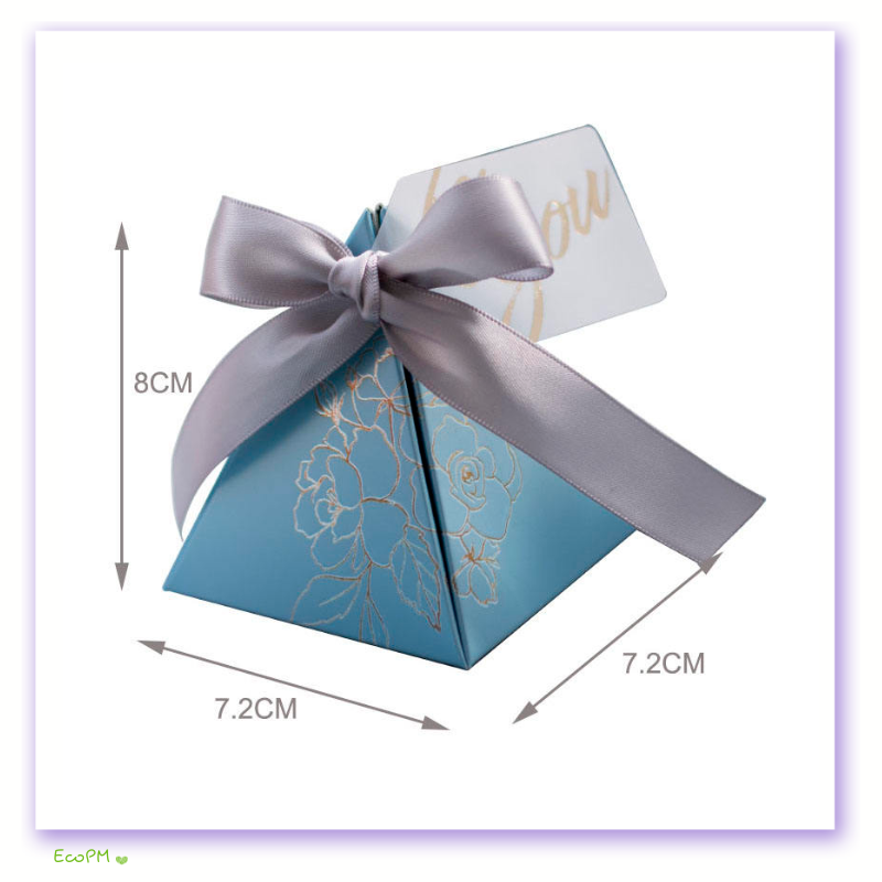 blue-pyramid-favor-box-silver-floral.png A charming blue pyramid favor box featuring a silver floral design and a graceful satin ribbon, perfect for elegant event giveaways.