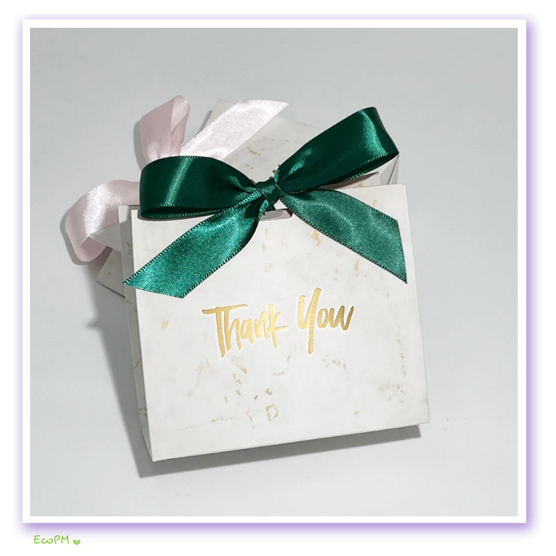 emerald-grace-thank-you-gift-box.png White marble patterned gift box with emerald green satin ribbon and gold 'Thank You' message.