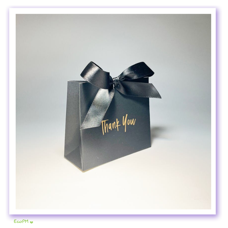 sophisticated-black-thank-you-gift-box-black-satin-ribbon.png A single black gift box with a shimmering black satin ribbon and golden