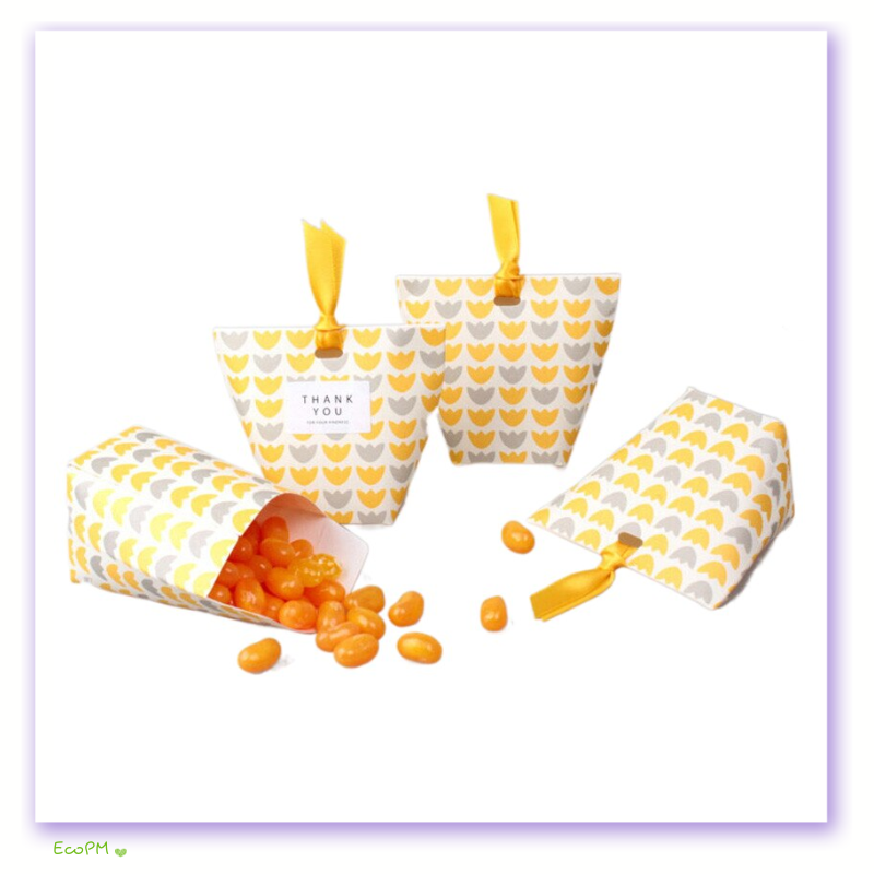 sunshine-hearts-favor-boxes-with-yellow-ribbon.png Bright yellow and white heart-patterned favor boxes with yellow ribbons, with one box spilling jelly beans.