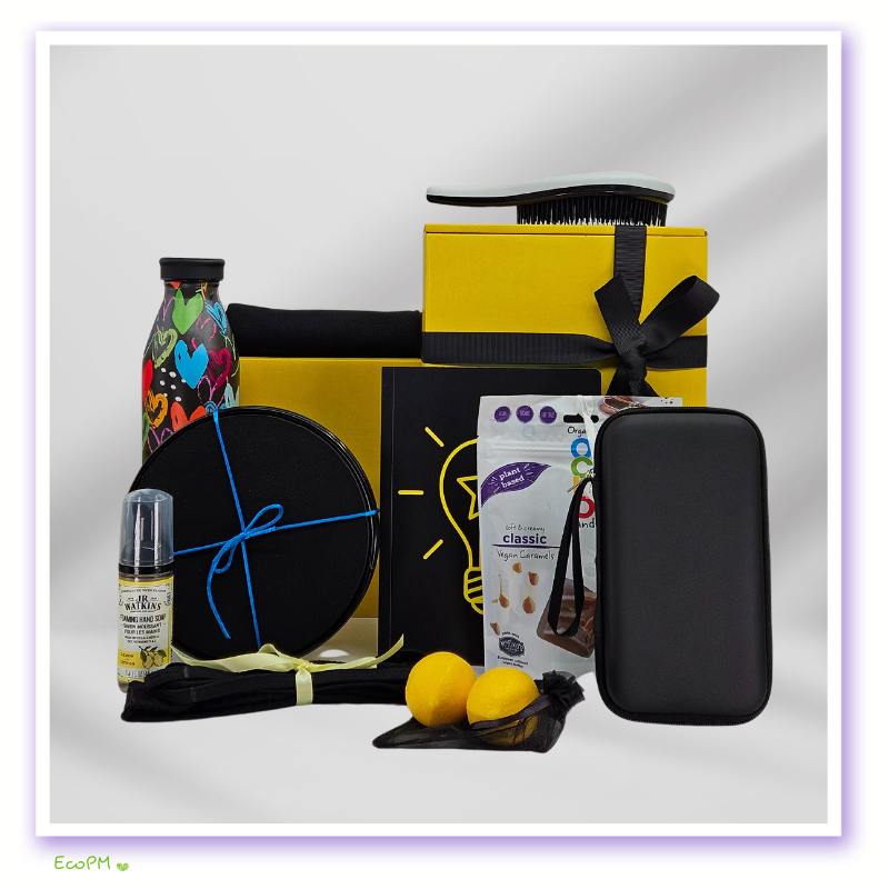 vibrant-yellow-gift-box-full.jpg Full vibrant yellow eco-friendly gift box with vegan treats, fitness accessories, water bottle, and wellness products.