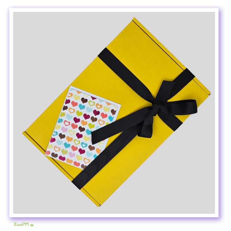 vibrant-yellow-gift-box-with-heart-card.jpg Bright yellow eco-friendly gift box with black ribbon and colorful heart card.