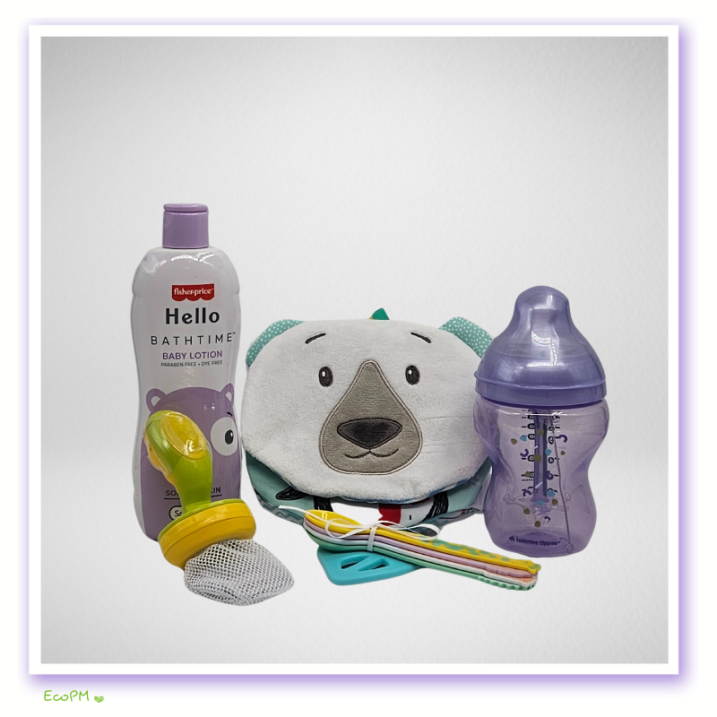 blissful-baby-care-newborn-essentials-single-setup.jpg Baby comfort and care items with plush bear and feeding bottle