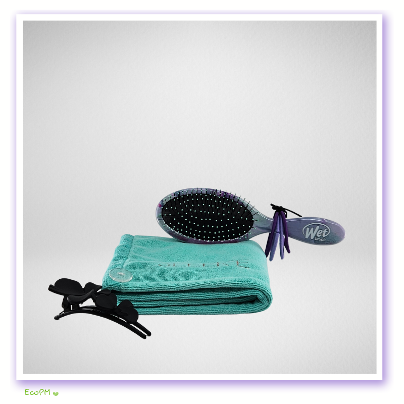 microfiber-hair-wrap-and-wet-brush-set.jpg Turquoise towel with a detangling brush and black hair clips on a white background.