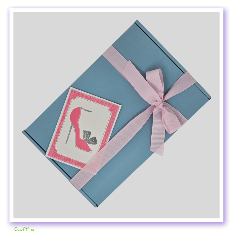 stylish-gift-box-with-shoe-design-card.jpg Stylish blue gift box tied with pink ribbon and elegant shoe-themed card.