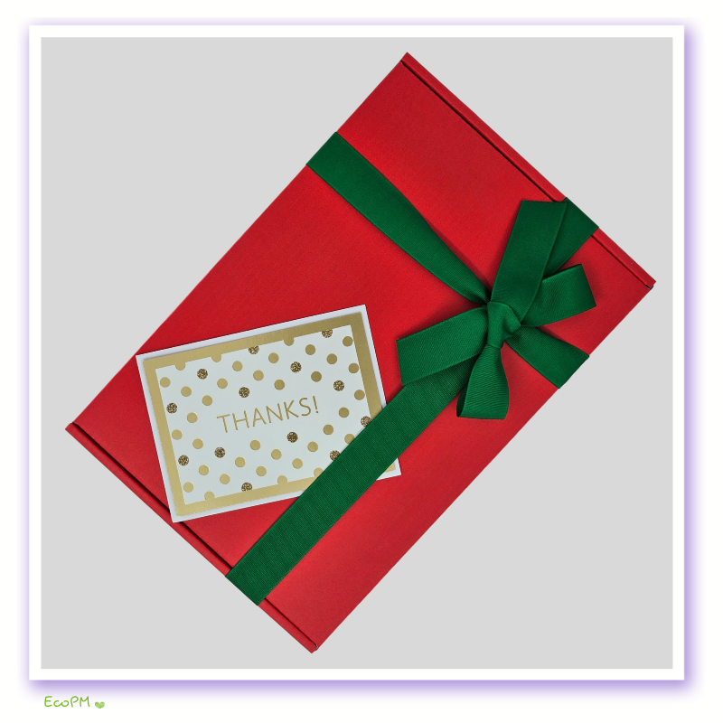 vibrant-red-elegance-box-closed.jpg Red gift box with green ribbon and polka dot thanks card, expressing stylish gratitude.