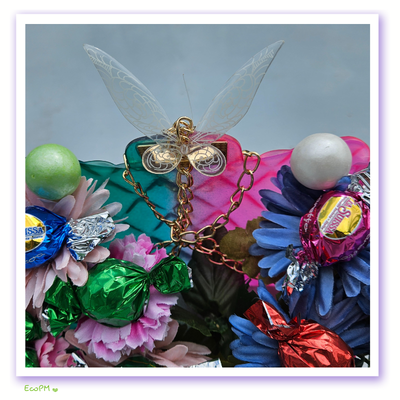 eco-party-floral-chocolate-bag-3.png Close-up of butterfly decoration on eco-friendly floral bag with chocolates